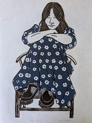 Lino print of a dreaming girl wearing a blue daisy print dress