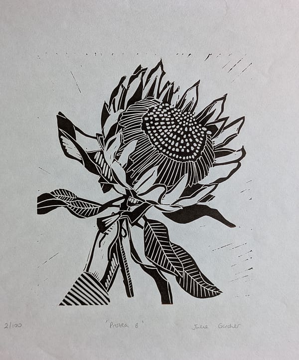 Lino print of a hand holding a protea flower