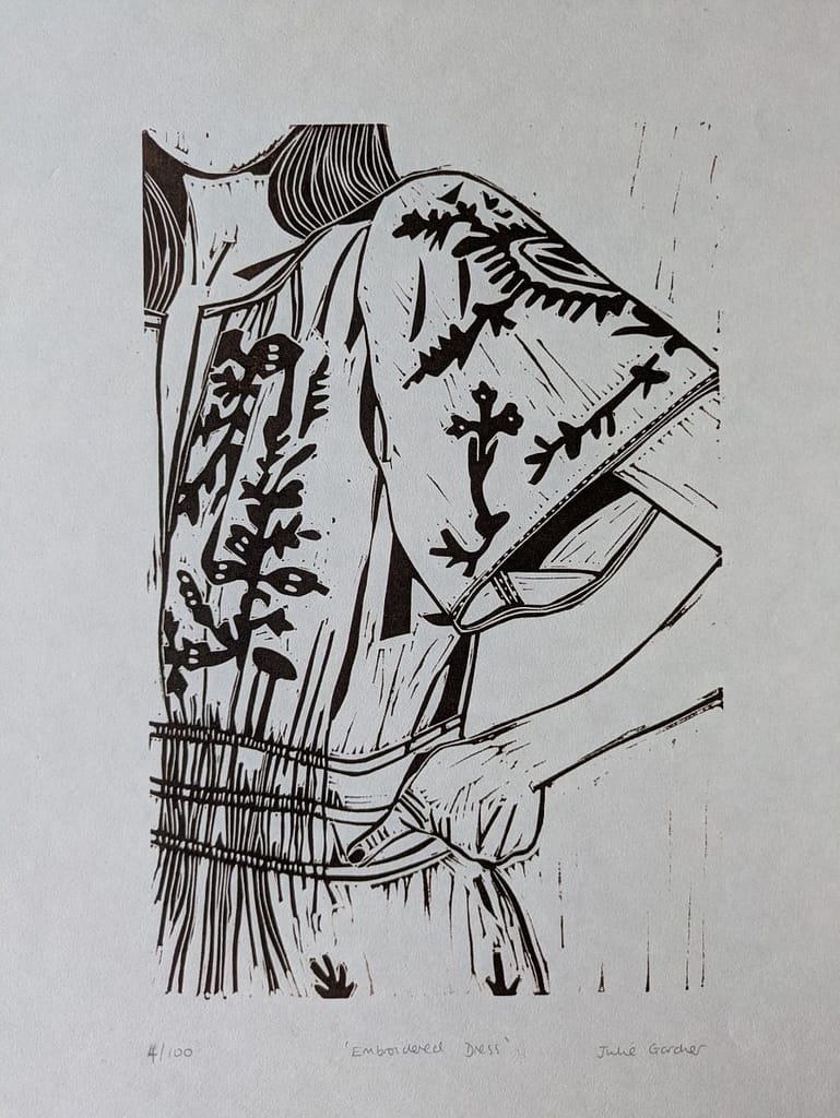 Lino print of a girl wearing an embroidered dress