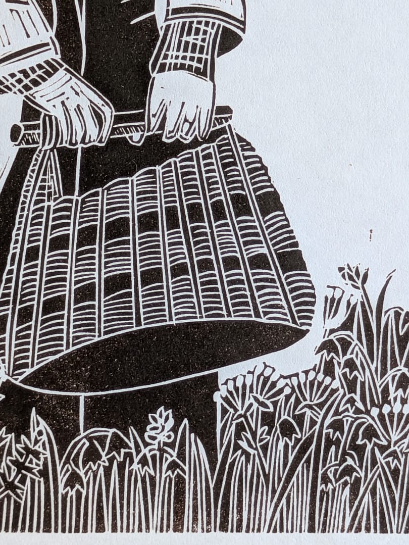 Lino print of a girl holding a basket in a flower meadow