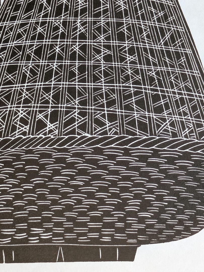 Lino print of a girl holding a large woven basket