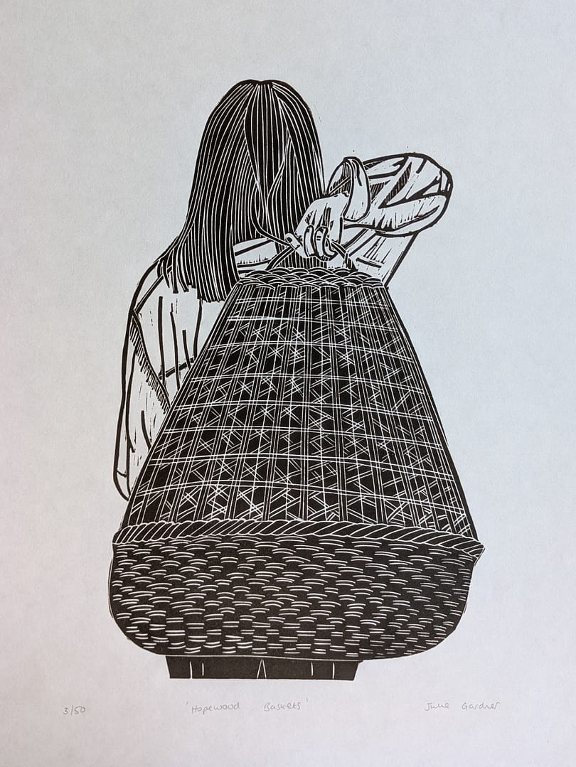 Lino print of a girl holding a large woven basket
